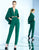 Ieena Duggal  - 25240i Caped V Neck Jumpsuit with Metallic Belt in Green